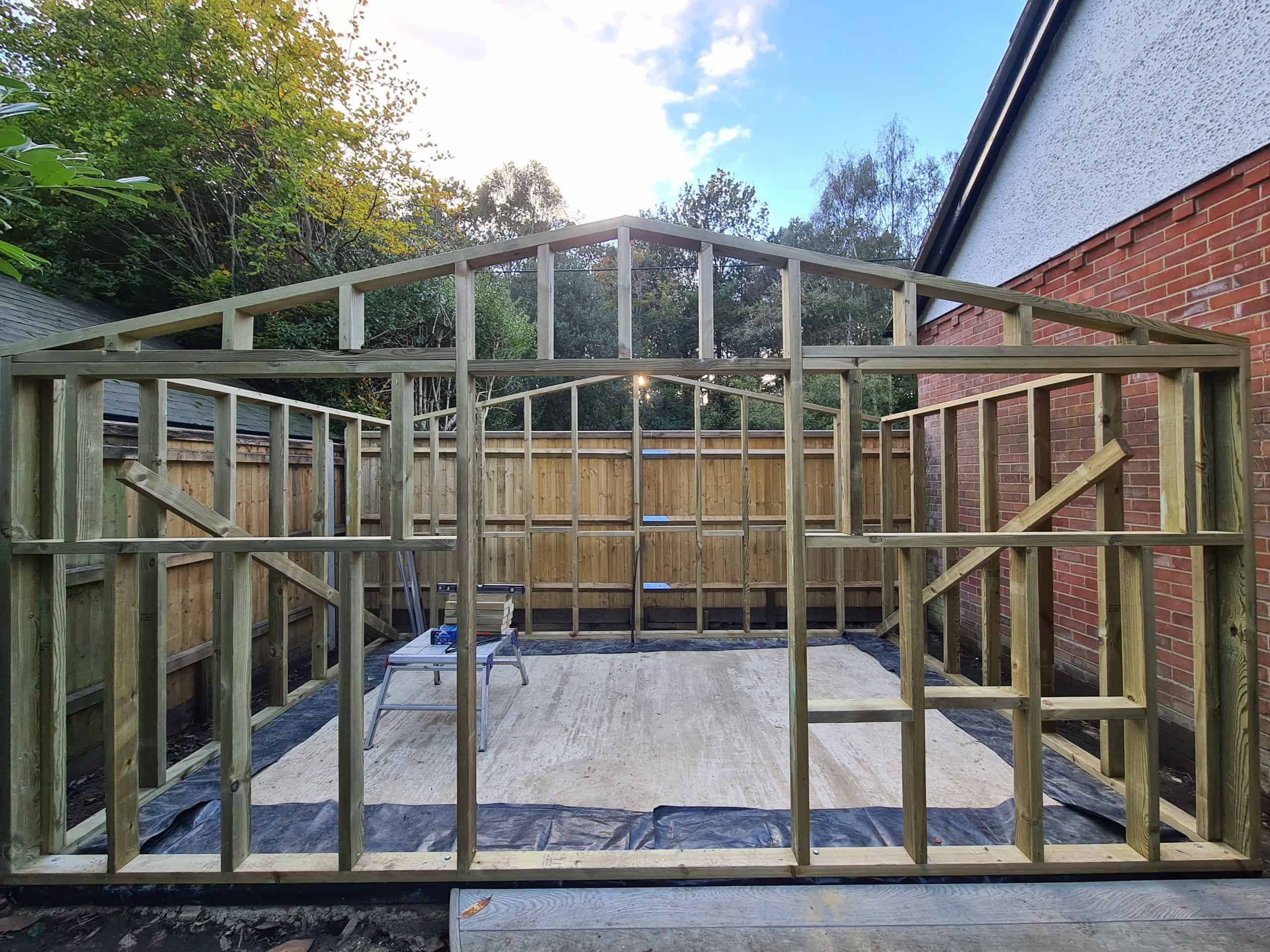 Garden gym timber framework installation showing custom roof height=